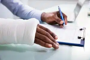 An injured man filling out a workers’ comp application.