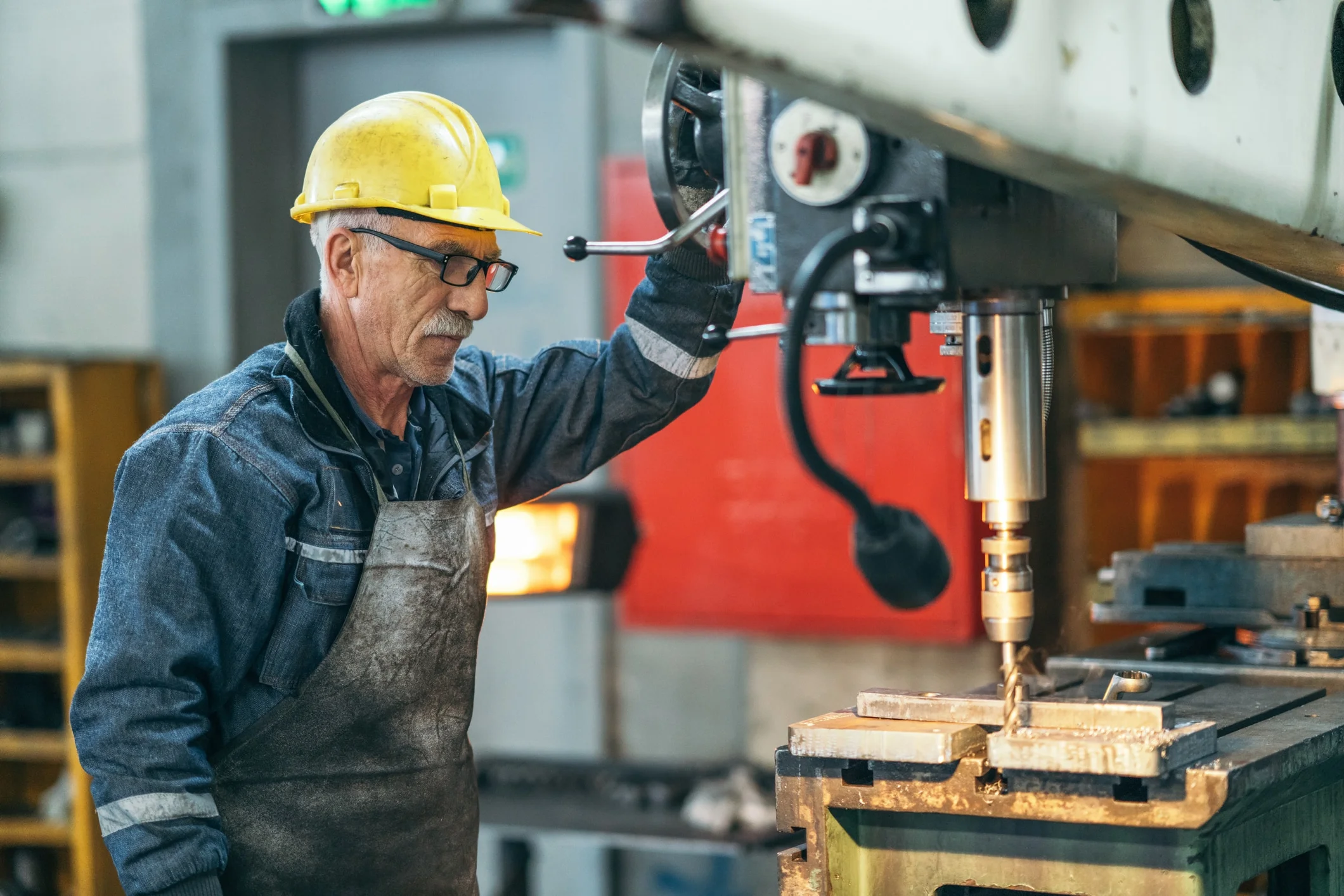 A man working at a machine in a factory.